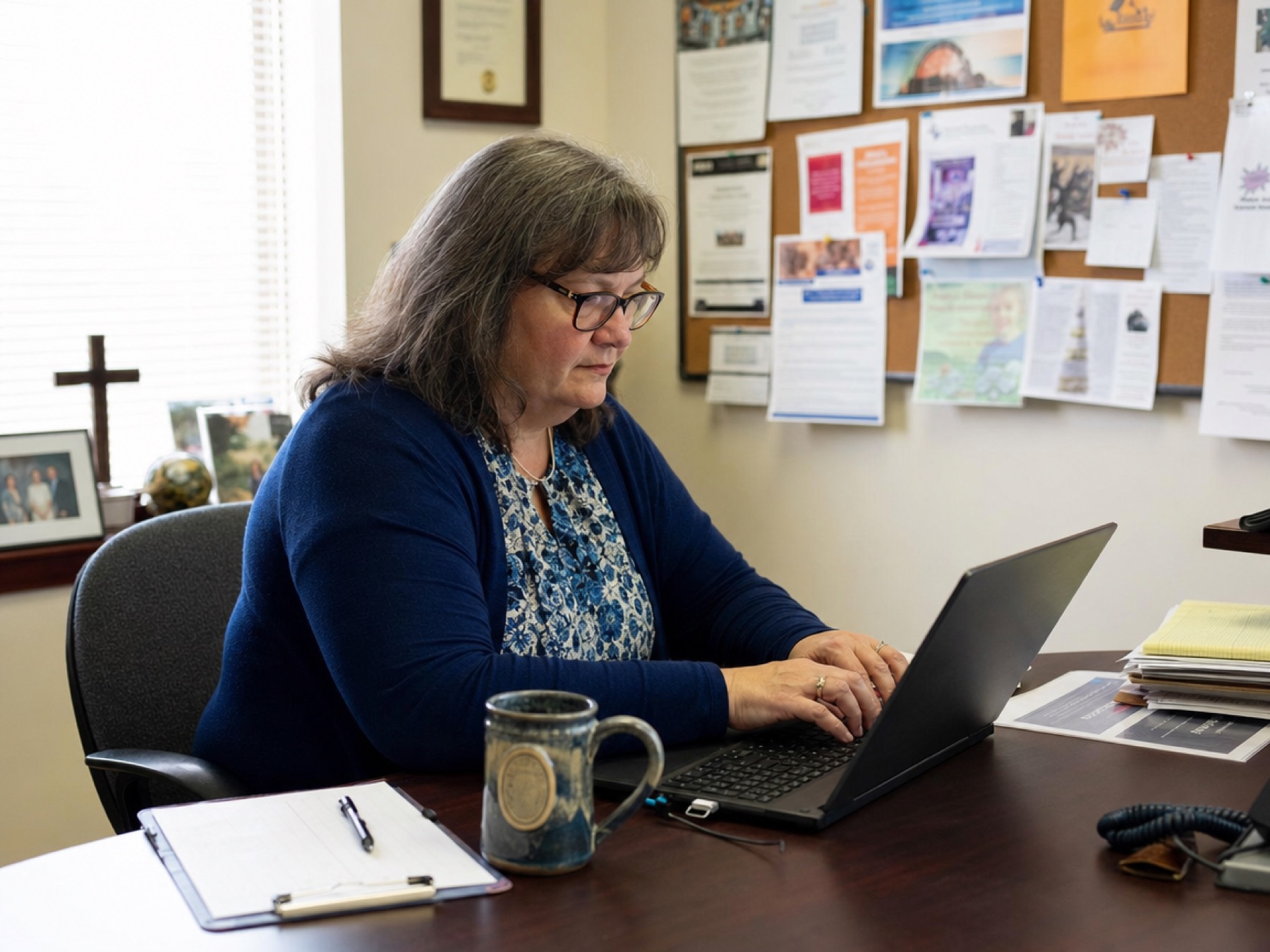 Church administrator updating a member list in a church office