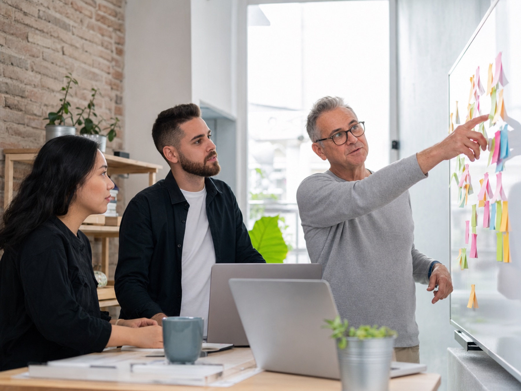 Startup founders planning around a standing desk